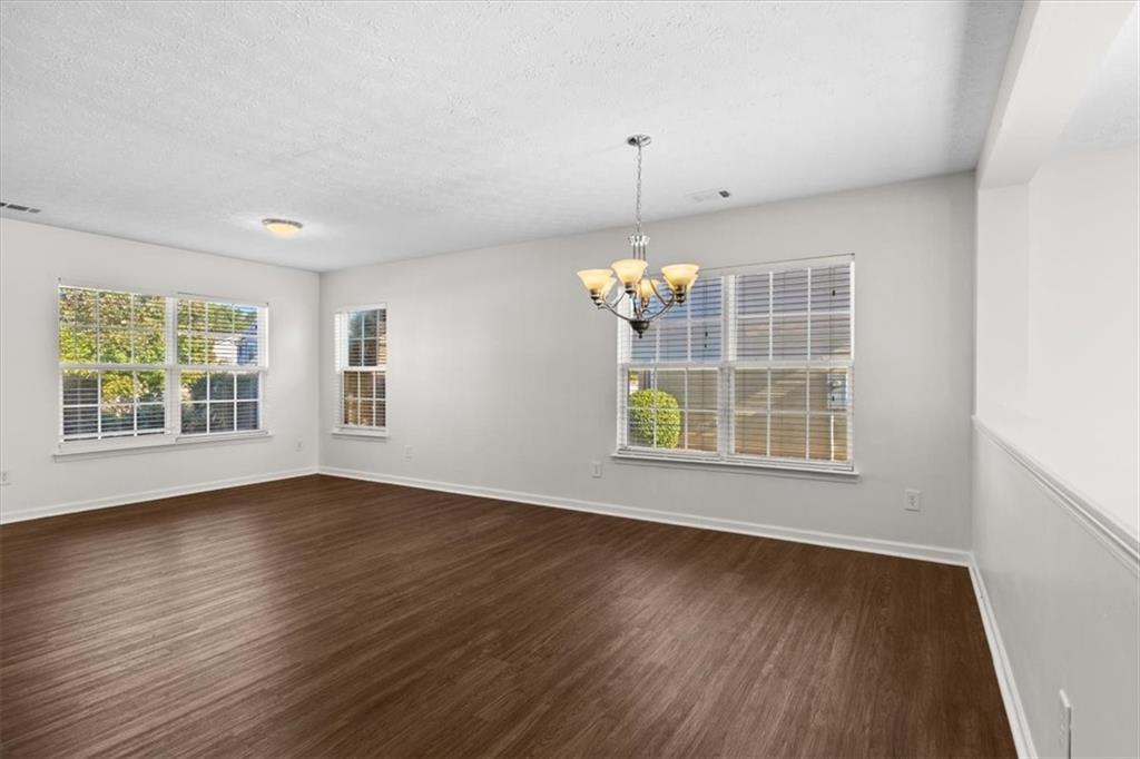 2068 White Top Road Southeast Lawrenceville, GA 30045 - Photo 7 of 41 a view of an empty room with a window and wooden floor
