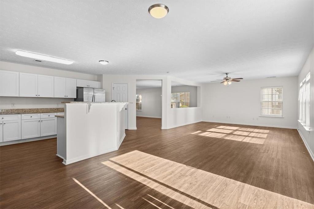 2068 White Top Road Southeast Lawrenceville, GA 30045 - Photo 8 of 41 a view of a kitchen with wooden floor and a sink