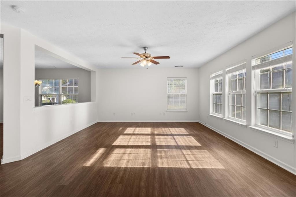 2068 White Top Road Southeast Lawrenceville, GA 30045 - Photo 10 of 41 a view of an empty room with a window and wooden floor