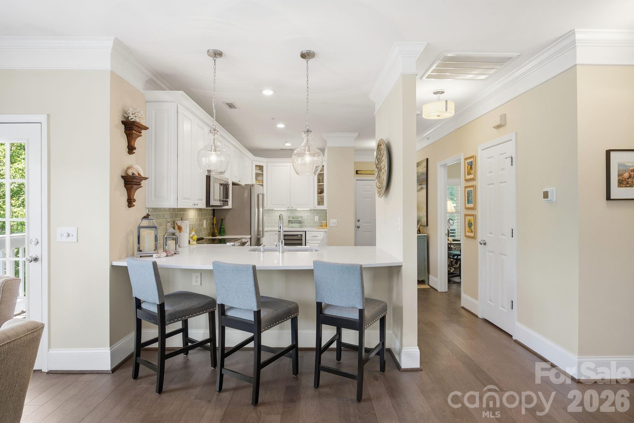 8942 Rosalyn Glen Road Cornelius, NC 28031 - Photo 1 of 47 a dining room with stainless steel appliances a table and chairs