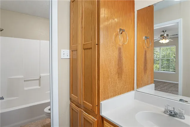 a bathroom with a shower and a sink