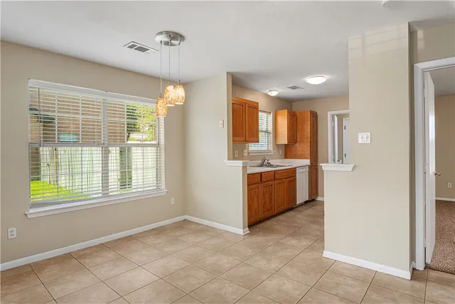a kitchen with a refrigerator and a stove top oven