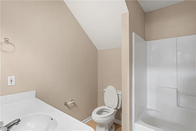 a white toilet sitting next to a bathroom sink