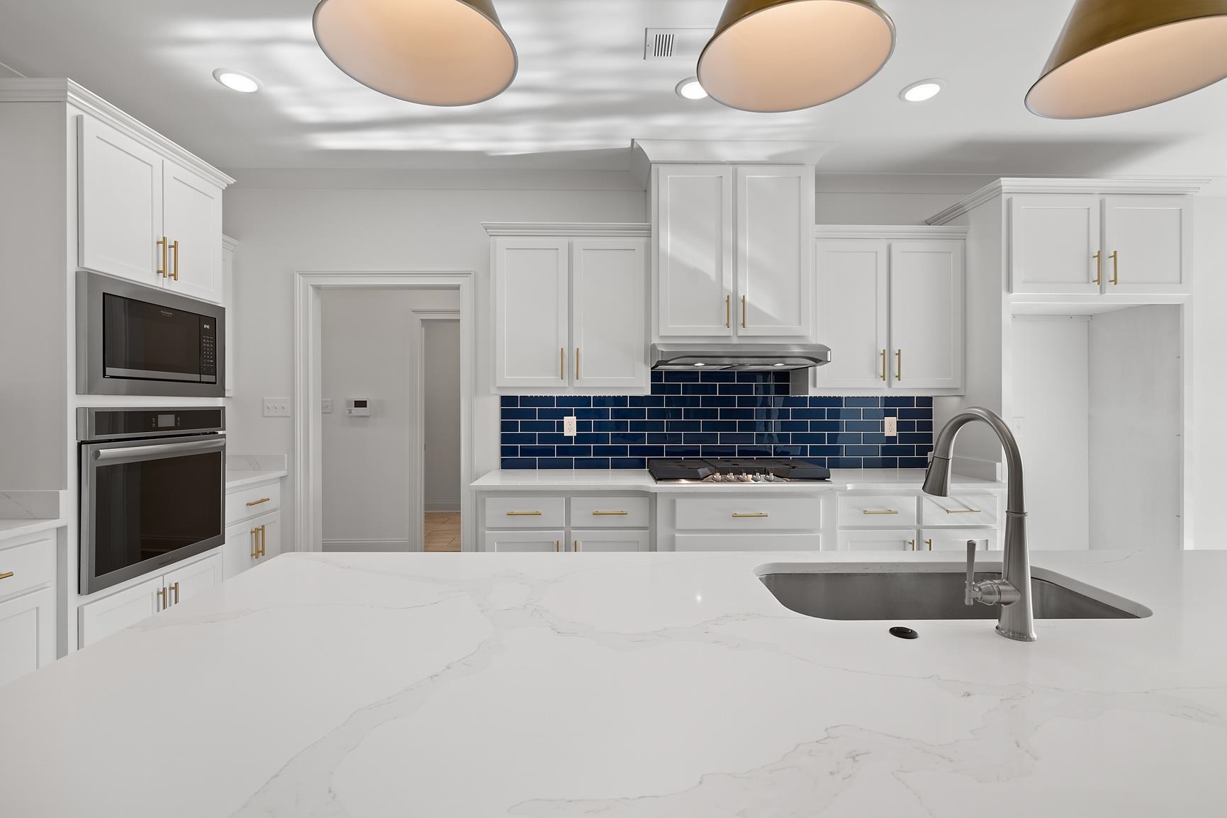 822 Leta Loop Brighton, TN 38011 - Photo 12 of 40 a kitchen with stainless steel appliances kitchen island granite countertop a stove and white cabinets