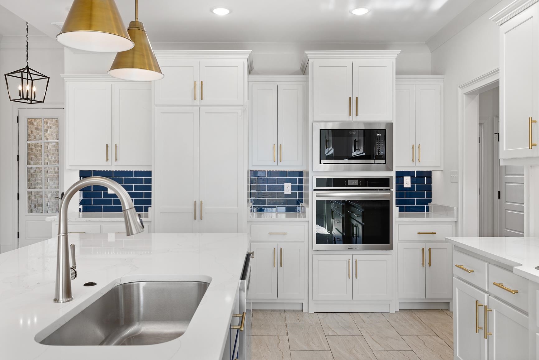 822 Leta Loop Brighton, TN 38011 - Photo 17 of 40 a kitchen with white cabinets and stainless steel appliances