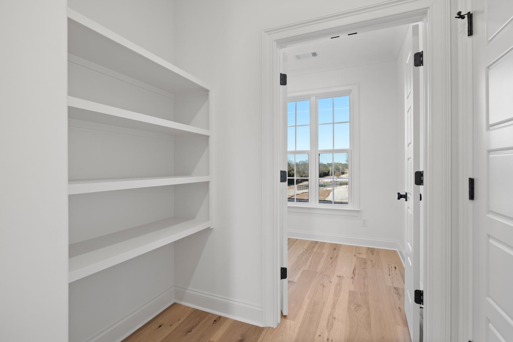 822 Leta Loop Brighton, TN 38011 - Photo 21 of 40 a view of kitchen with wooden floor and window