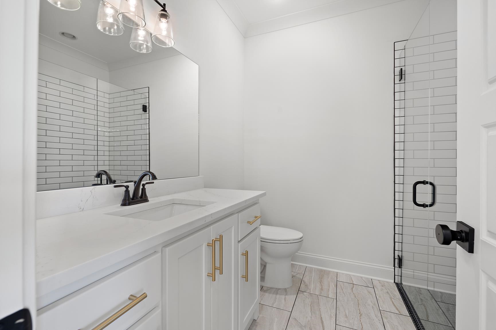 822 Leta Loop Brighton, TN 38011 - Photo 35 of 40 a bathroom with a sink a toilet a mirror and shower