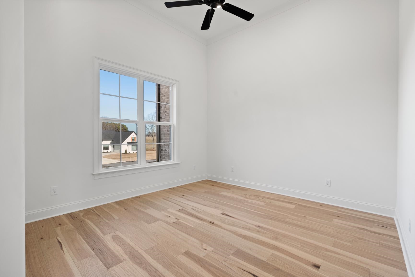 822 Leta Loop Brighton, TN 38011 - Photo 37 of 40 an empty room with wooden floor fan and windows