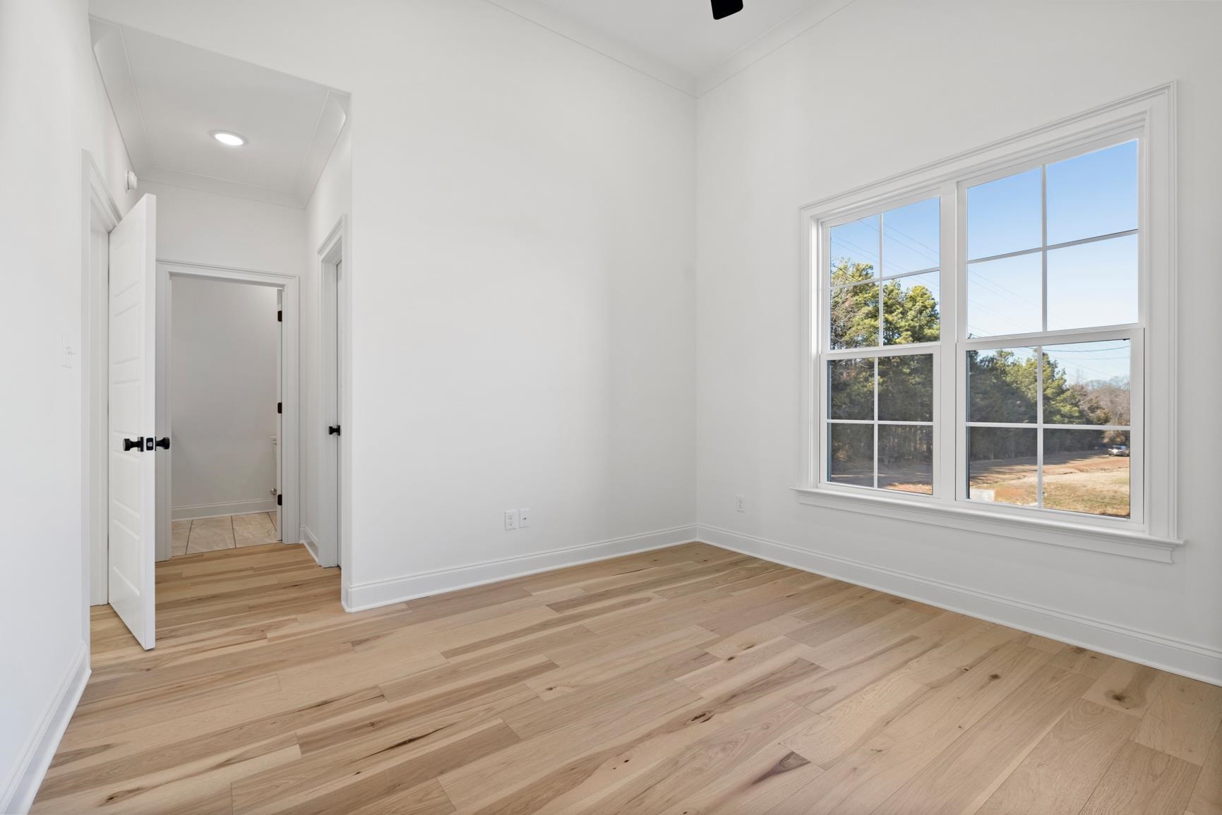 822 Leta Loop Brighton, TN 38011 - Photo 38 of 40 a view of an empty room with wooden floor and a window