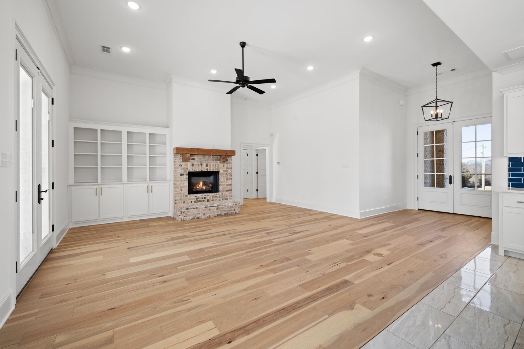 822 Leta Loop Brighton, TN 38011 - Photo 8 of 40 an empty room with wooden floor fireplace and windows