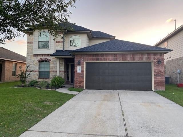 22438 Toronado Ridge Lane Porter, TX 77365 - Photo 1 of 19 Charming two-story brick home with a spacious driveway and lush front lawn, perfect for family living.