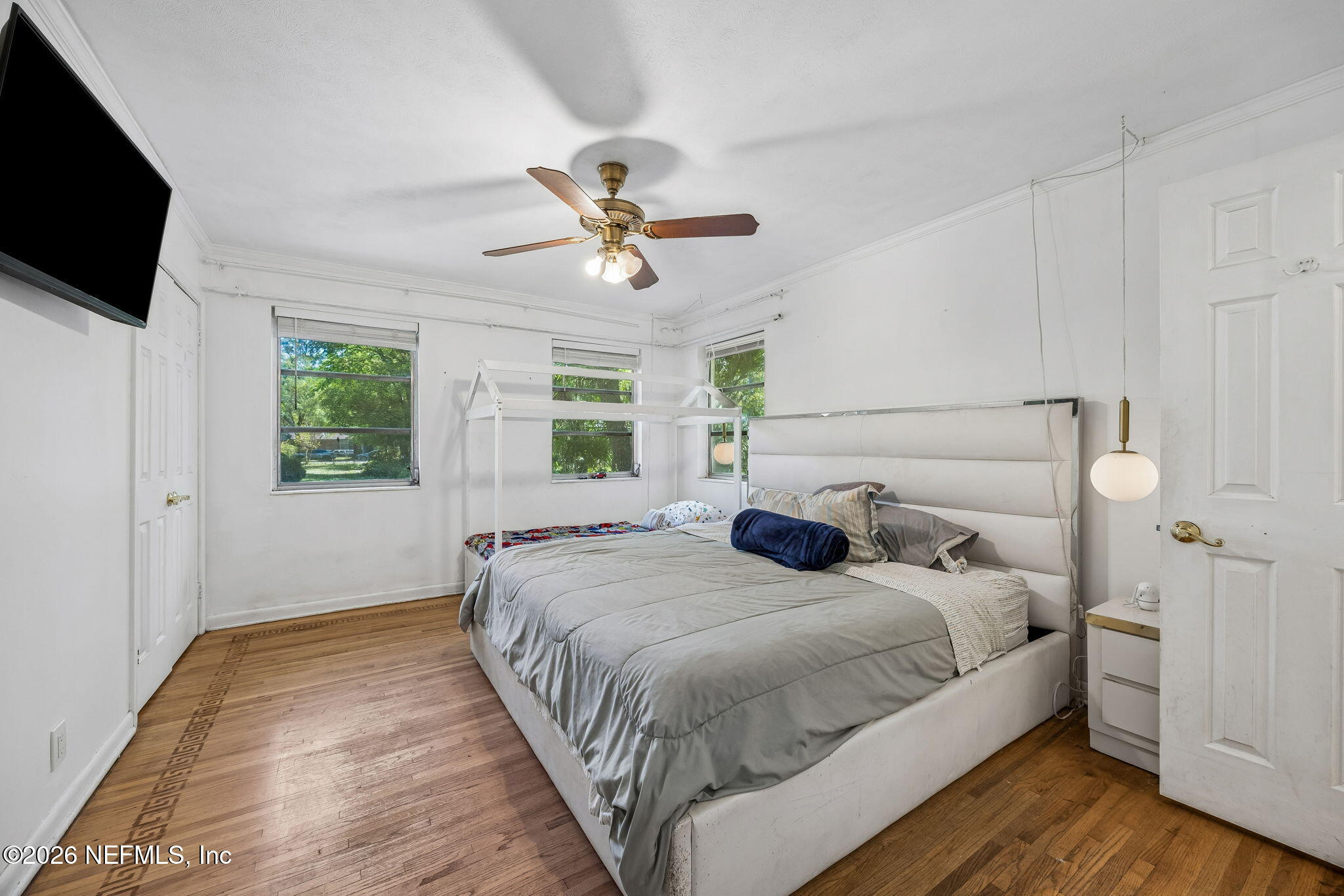 5136 Eulace Road Jacksonville, FL 32210 - Photo 16 of 41 a bedroom with a large bed and a flat screen tv