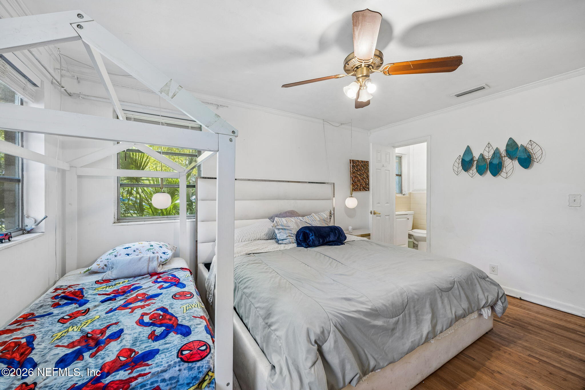5136 Eulace Road Jacksonville, FL 32210 - Photo 17 of 41 a bedroom with a bed and a chandelier