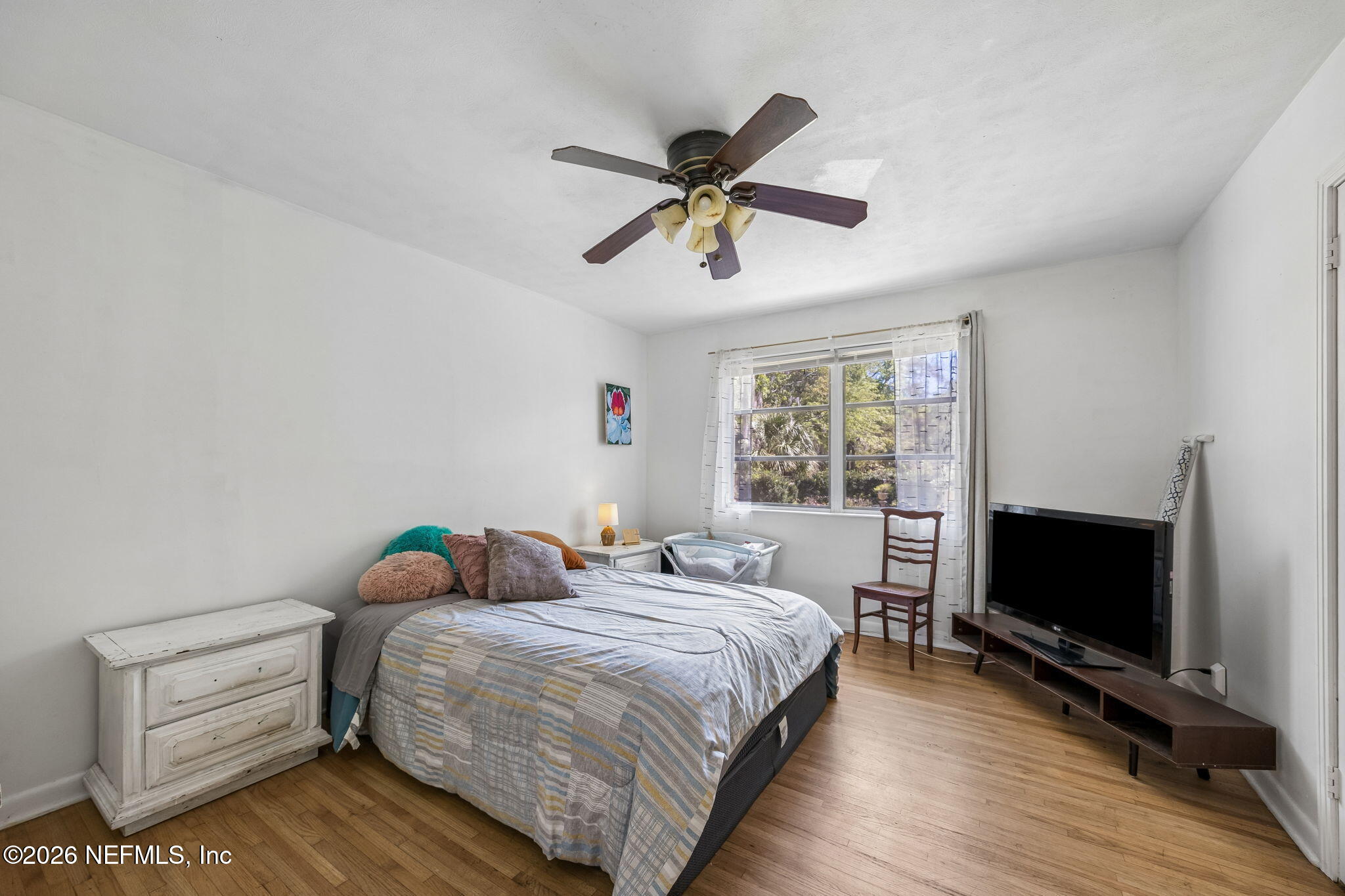 5136 Eulace Road Jacksonville, FL 32210 - Photo 19 of 41 a bedroom with a bed and a flat screen tv