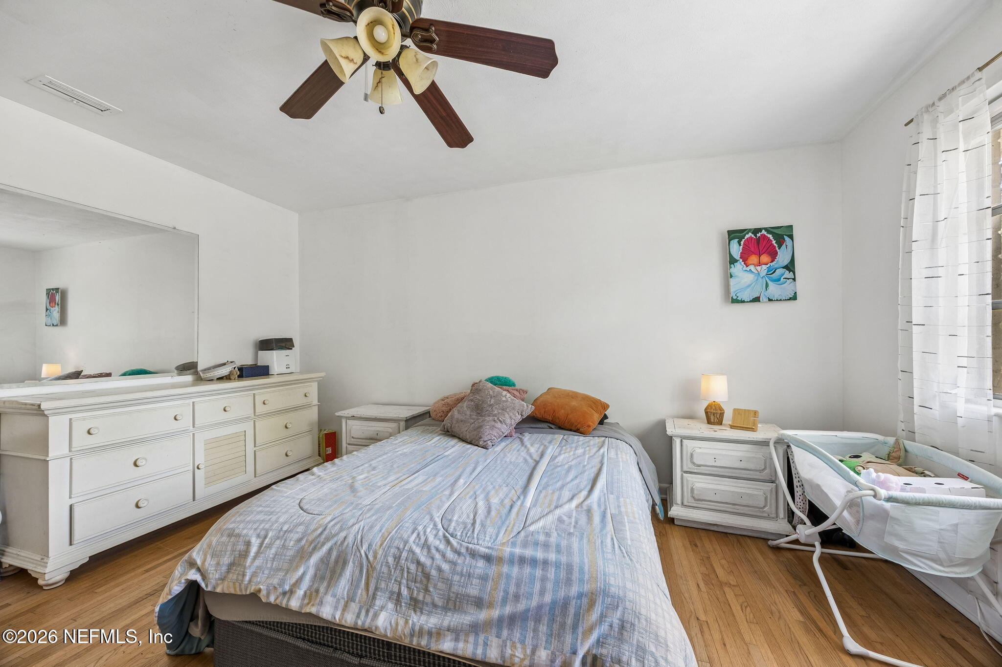 5136 Eulace Road Jacksonville, FL 32210 - Photo 20 of 41 a bedroom with a bed and a chandelier