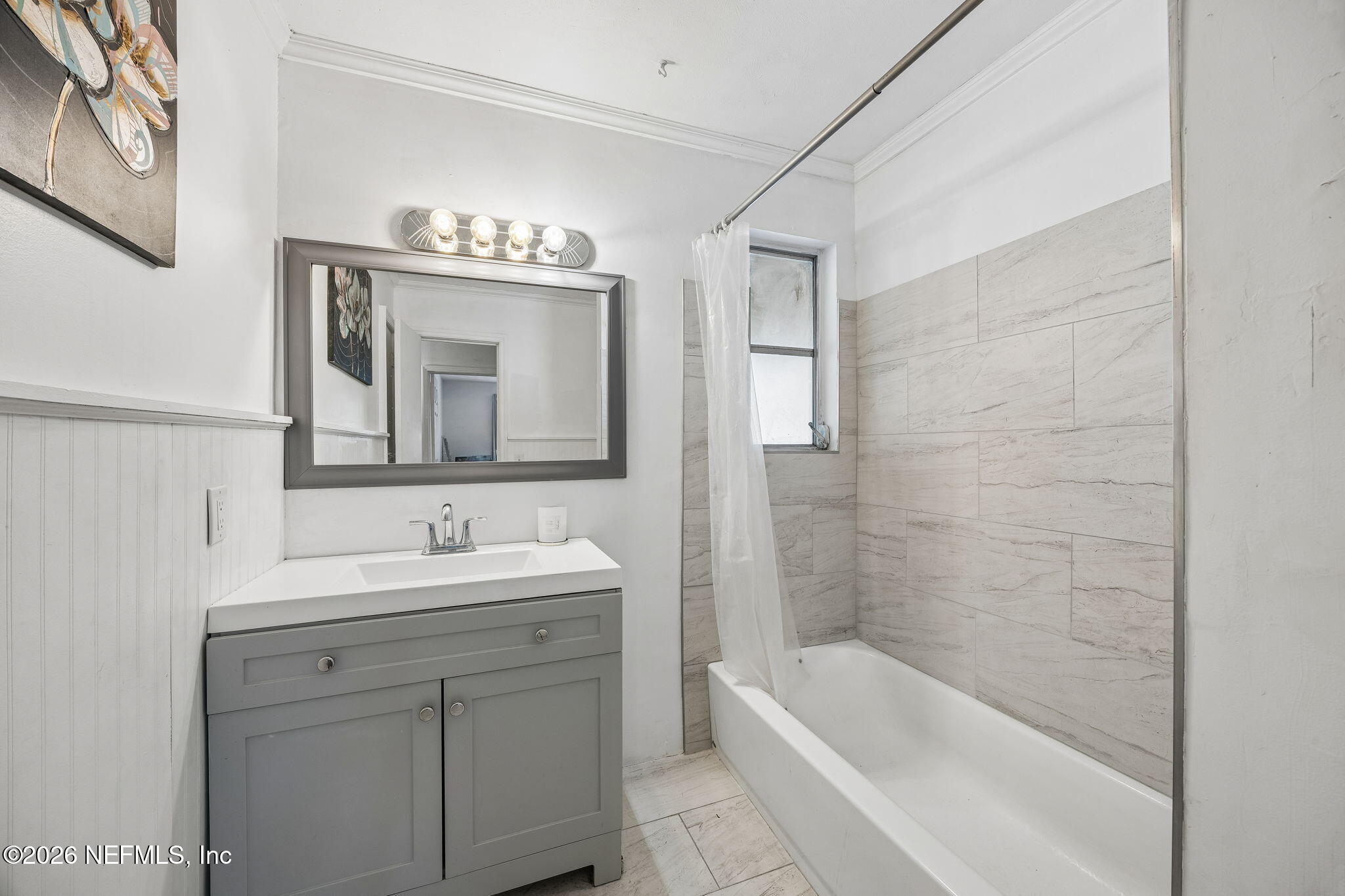 5136 Eulace Road Jacksonville, FL 32210 - Photo 21 of 41 a bathroom with a bathtub sink and mirror
