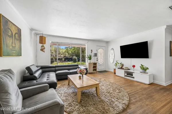 a living room with furniture and a flat screen tv