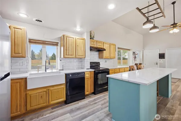 a large kitchen with a table and chairs