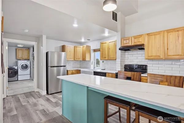 a kitchen with a refrigerator and a sink