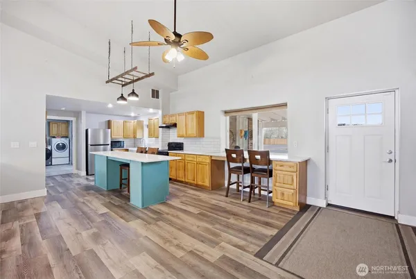 a kitchen with stainless steel appliances granite countertop a sink stove and refrigerator
