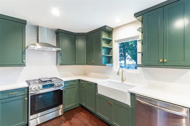 a kitchen with stainless steel appliances sink stove and microwave