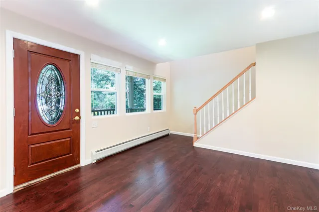 a view of an entryway with wooden floor