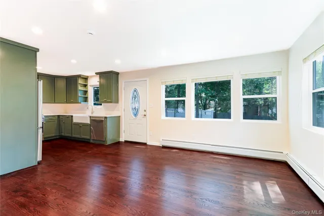 a view of a kitchen with furniture and wooden floor