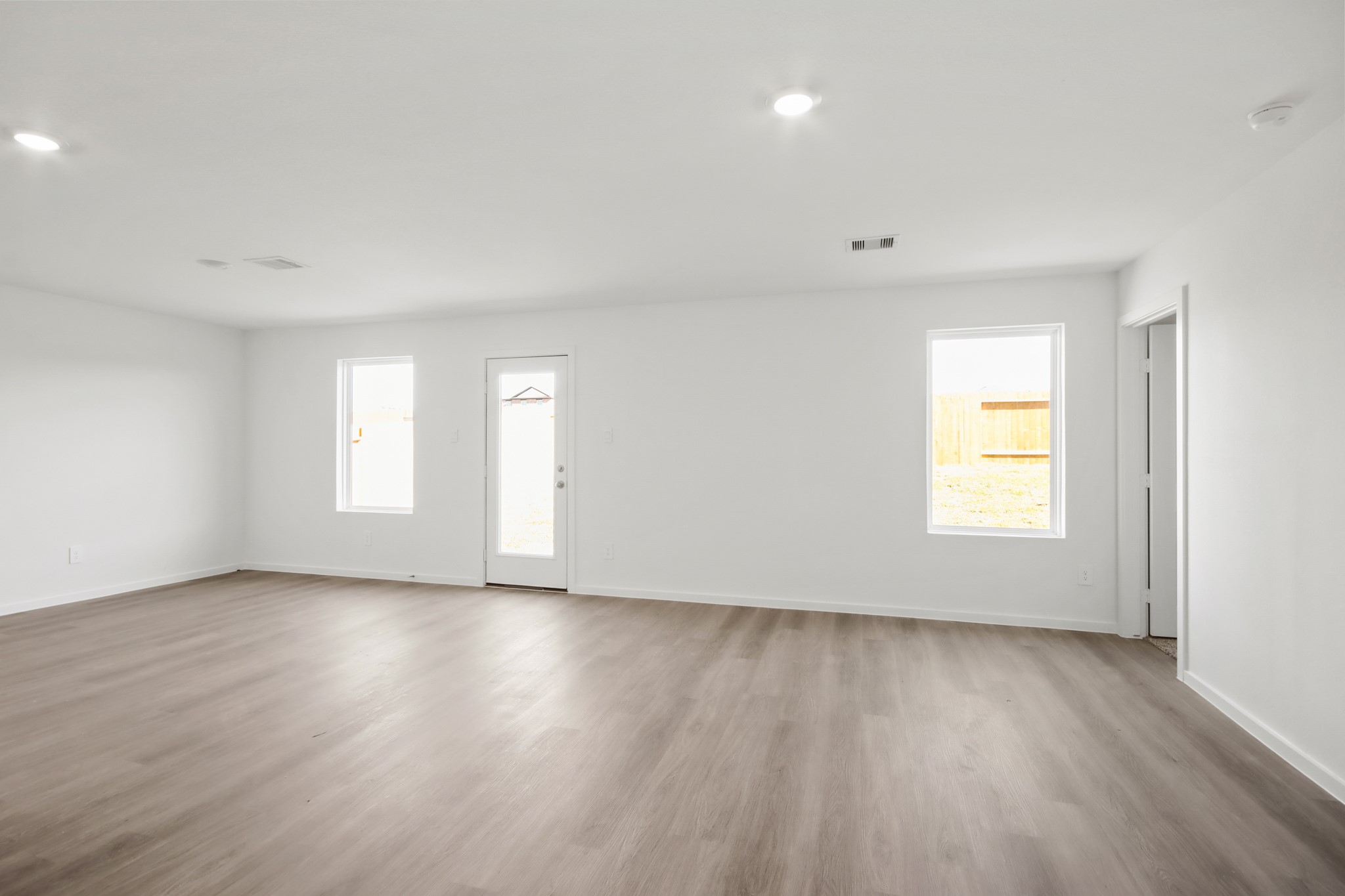 22010 Vernazza Bend Hockley, TX 77447 - Photo 8 of 36 an empty room with wooden floor and windows