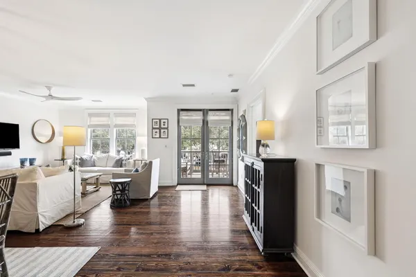 a living room with furniture and wooden floor