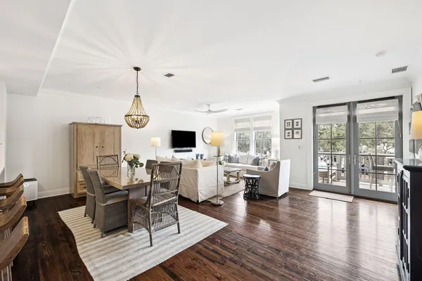 a living room with furniture a fireplace and a chandelier