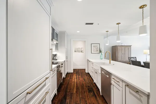 a kitchen with granite countertop white cabinets and white appliances