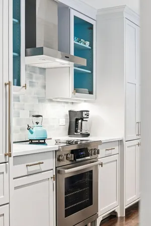a kitchen with stainless steel appliances a white cabinets and a wooden floors