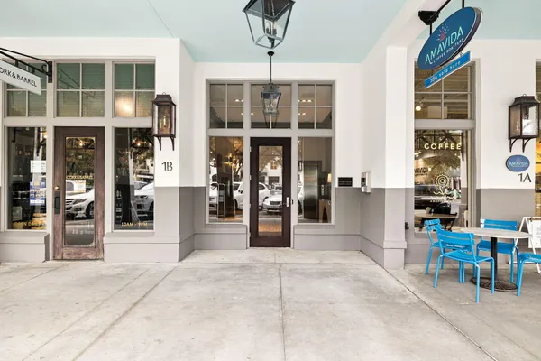 a kitchen with stainless steel appliances a refrigerator and a wooden floor
