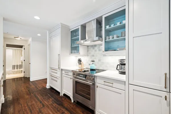 a kitchen with cabinets wooden floor and a sink