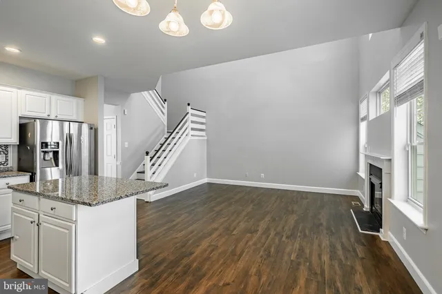 a view of kitchen and hall with wooden floor