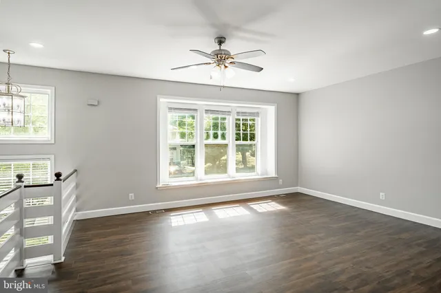a view of a livingroom with a window and wooden floor