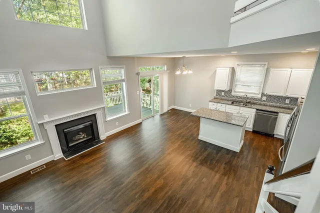 a living room with furniture wooden floor and a fireplace