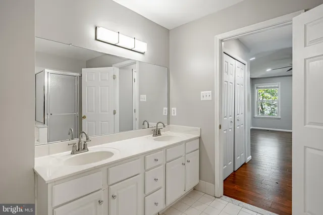 a bathroom with double sink and three mirror