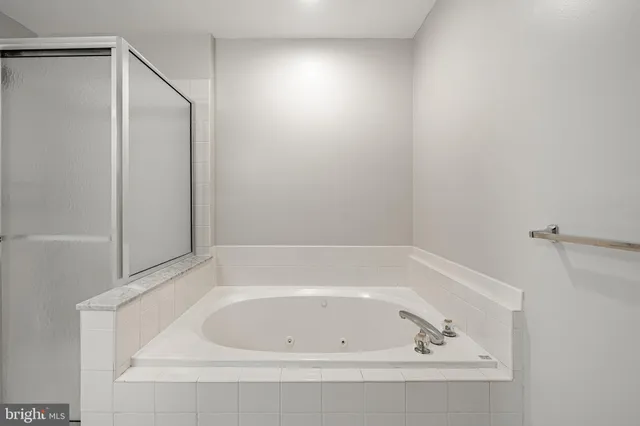 a white bath tub and shower in a bathroom