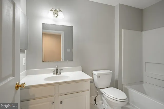 a bathroom with a toilet a sink and a mirror