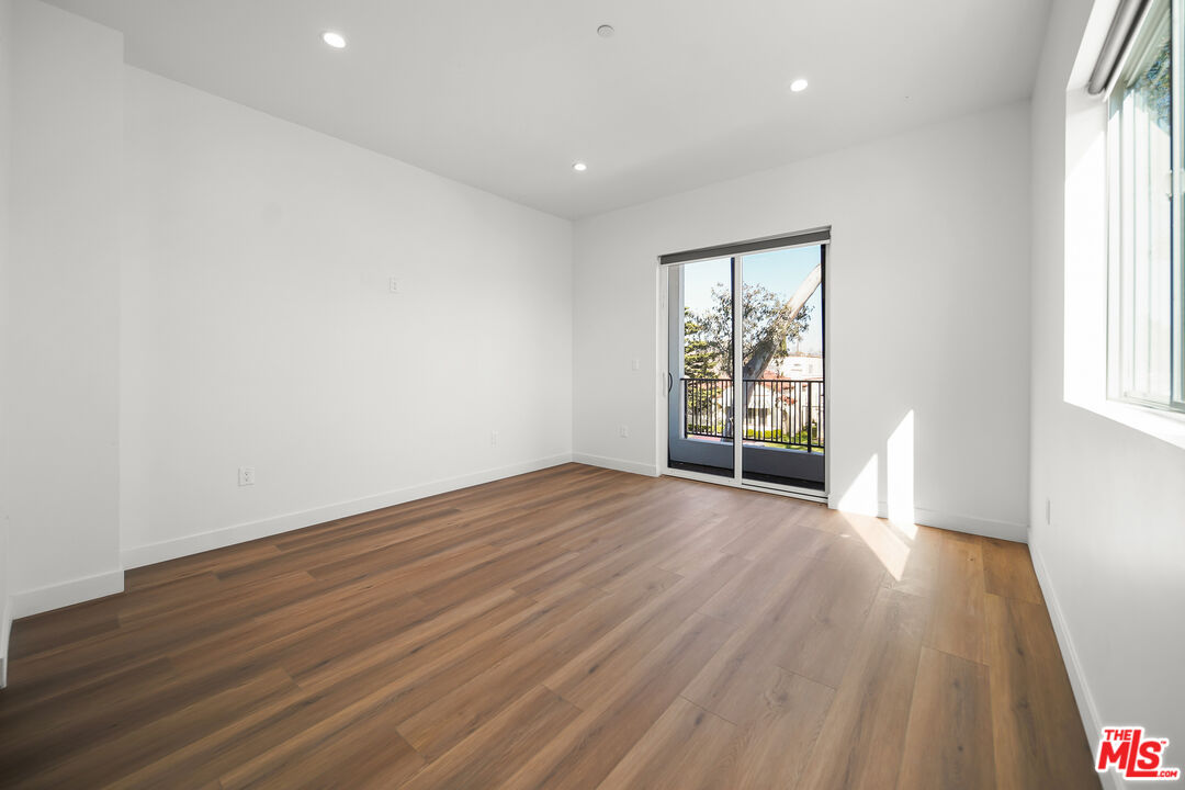 1905 South Corning Street, Unit 2 Los Angeles, CA 90034 - Photo 11 of 26 an empty room with wooden floor and windows