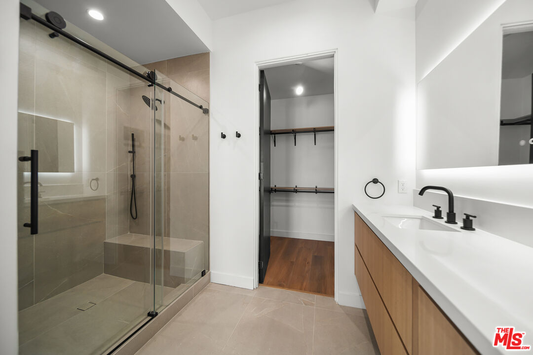 1905 South Corning Street, Unit 2 Los Angeles, CA 90034 - Photo 19 of 26 a bathroom with a shower sink and mirror