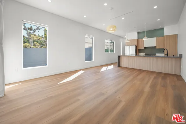 a view of kitchen with kitchen island microwave and wooden floor