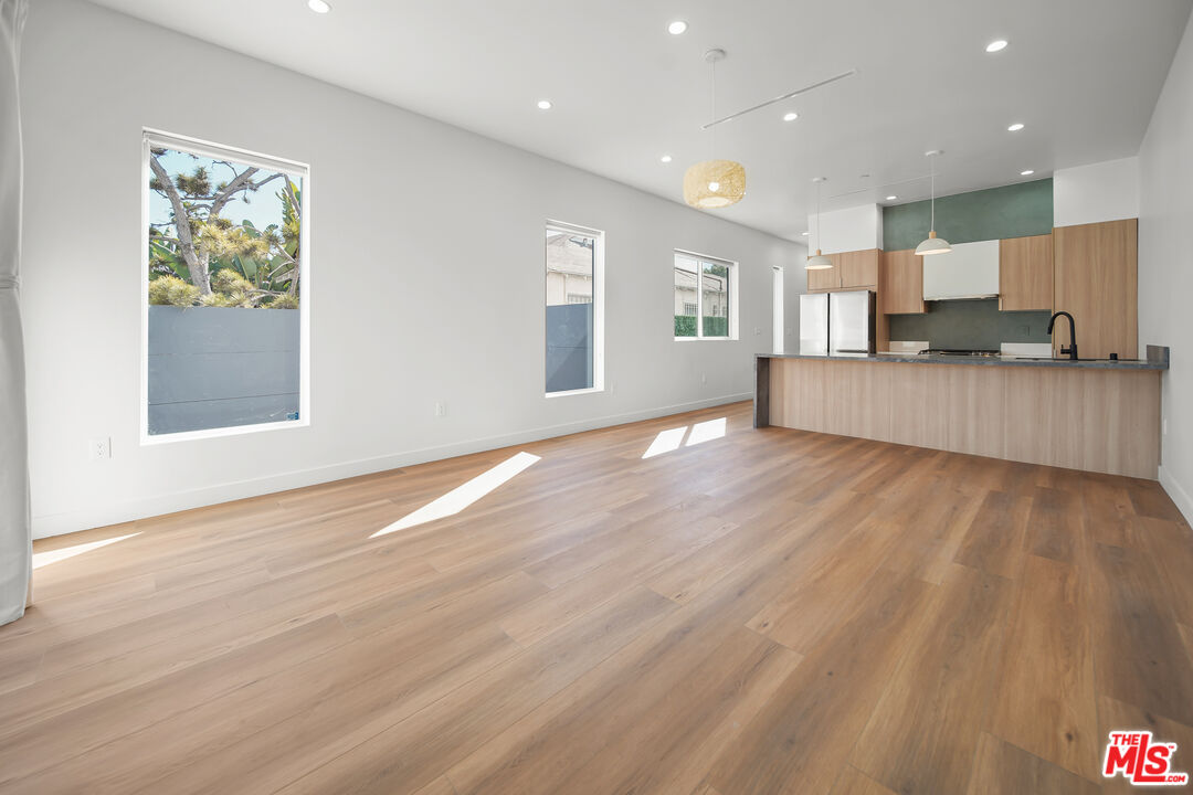 1905 South Corning Street, Unit 2 Los Angeles, CA 90034 - Photo 2 of 26 a view of kitchen with kitchen island microwave and wooden floor