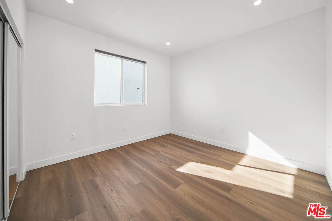 1905 South Corning Street, Unit 2 Los Angeles, CA 90034 - Photo 23 of 26 an empty room with wooden floor and windows