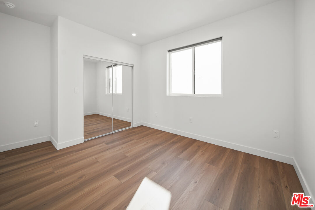 1905 South Corning Street, Unit 2 Los Angeles, CA 90034 - Photo 24 of 26 an empty room with wooden floor and windows