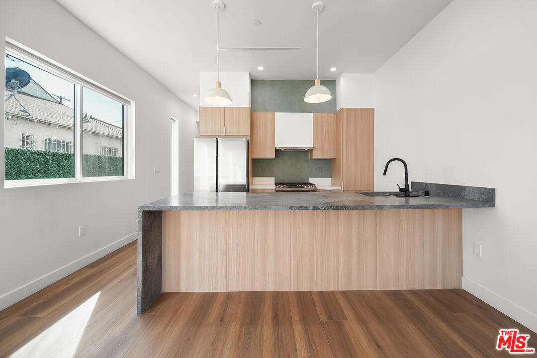 1905 South Corning Street, Unit 2 Los Angeles, CA 90034 - Photo 4 of 26 a kitchen with a sink wooden floor and a window
