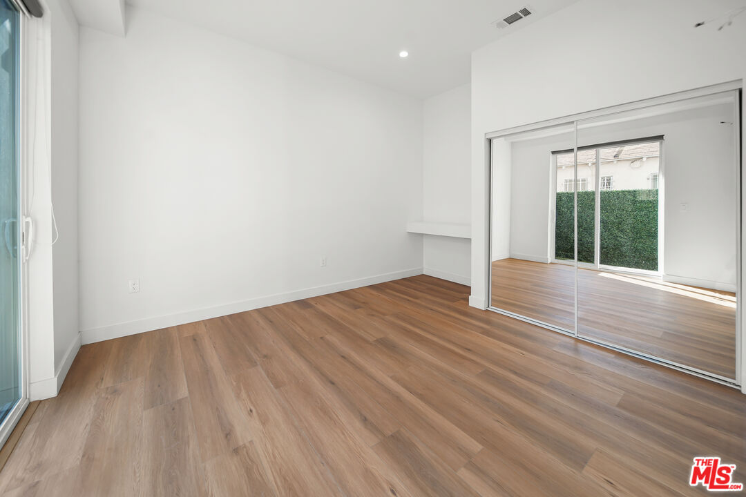 1905 South Corning Street, Unit 2 Los Angeles, CA 90034 - Photo 8 of 26 wooden floor in an empty room with a window