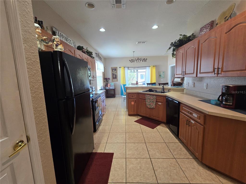 219 Cloverdale Road Winter Haven, FL 33884 - Photo 9 of 29 a kitchen with stainless steel appliances granite countertop a refrigerator a sink dishwasher a stove top oven a refrigerator and cabinets