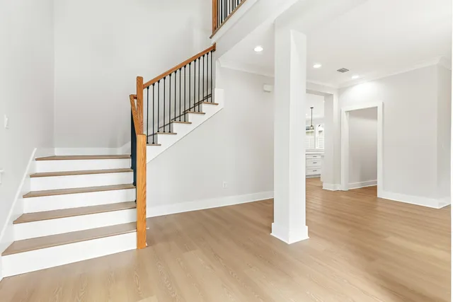a view of empty room with wooden floor and window